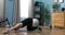 Sport muscle young man doing push up workout in indoor room with exterior daylight. Strong Athletic Fit Man in a Black T-Shirt and