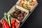 Sport nutrition with pasta, fried liver and fresh vegetables in plate on black background. Healthy food, dieting, top view.