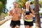 Sport people - active couple running in city