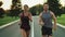 Sport people running in park together. Young couple jogging at outdoor workout