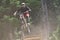 Sport race Mountain biker extreme and fun downhill track. Jumps and dirt splashes.