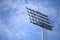 Sport stadium spotlight with blue sky background. Football and soccer light lamp