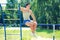 Sport, street workout concept - sportsman sitting on the horizontal bar