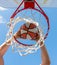 sport success. scoring while basketball game. ball goes through basket.