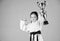 Sport success in single combat. practicing Kung Fu. happy childhood. winner little girl in gi sportswear. small girl