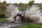 Sport SUV boosts water hurdle surrounded by splashes.