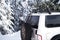 Sport SUV car with a Christmas tree on the trunk close-up. jeep in the mountains