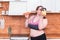 Sport with unhealthy food. combination of active life with fast food. close up photo. fat woman choosing kettlebell not hamburger