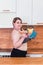 Sport with unhealthy food. combination of active life with fast food. close up photo. fat woman showing kettlebell and hot dog