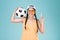Sport woman fan holding a soccer ball,celebrating point one finger up winner sign