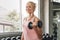 Sport woman lifting dumbbells weights focused exercise on her bicep for compact arm size