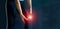 Sport woman suffering from pain in knee. Tendon problems and Joint inflammation on dark background. Healthcare and medical