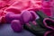 Sport, working out and bodybuilding concept with girly workout equipment like a pink pair of gym gloves, two dumbbells or weights