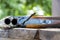 A sporting double-barreled shotgun lies on a wooden table, close-up, selective focus. bench target shooting.