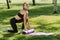 Sporting sexy girl spreads out in the park on the grass nod to yoga. outdoor sports training
