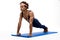 Sportive african man training on karemat over white background.