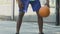 Sportive black man making tricks with ball, playing basketball, active lifestyle