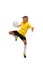 A sportive boy kicking a soccer ball. A little kid in a football uniform isolated on a white background. Sports concept.