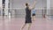 Sportive Caucasian men playing badminton indoors. Wide shot portrait of two young sportsmen exercising in gym. Athletic