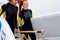 Sportive couple go to ocean. Cheerful Woman and man holding surfboard on beach