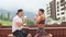 Sportive couple sitting in a cafe enjoying fresh drinks after intensive workout.