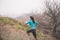 Sportive female climbing on hill in park