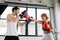 Sportive girl in boxing gloves punching