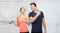 Sportive man and woman with dumbbell and water