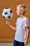 sportive soccer player boy spin the ball on his finger