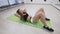 Sportive woman doing abs exercises to have flat belly, training in fitness club