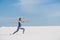 Sportive woman make warrior pose in desert