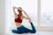 sportive woman near window meditation lifestyle fitness