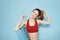 Sportive woman training mat in hands Red tank top exercise blue background