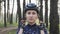 Sportive young girl wears black helmet before bicycle ride. She wears blue jersey. Cycling Concept