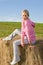 Sportive young woman relax on bales sunset