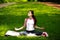 Sportive young woman relaxing in sunshine, doing yoga exercises