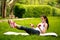 Sportive young woman stretching with dumbbells, doing fitness