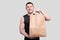 Sportman Holding Food Bag. Man with Paper Bag in Hands. Healthy Eating, Healthy Food, Sport Concept