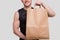 Sportman Holding Food Bag. Man with Paper Bag in Hands. Healthy Eating, Healthy Food, Sport Concept. Close Up