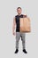 Sportman Holding Food Bag. Man with Paper Bag in Hands. Healthy Eating, Healthy Food, Sport Concept. Man standing Full
