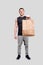 Sportman Holding Food Bag. Man with Paper Bag in Hands. Man Standing Full Lenght. Healthy Eating, Healthy Food, Sport