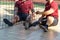 Sportmen with prosthetic legs sitting near the net during a match.