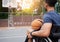 Sports, basketball court and man focus in wheelchair for playing competition, games and shoot outdoors. Fitness