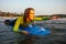 Sports beautiful woman in a diving suit lying on a surfboard waiting for a big wave .surf girl in a wetsuit surfing in