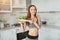 Sports beautiful young girl does salad after a hard workout fitness