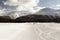 A sports car on the ice speeding and burning tires in winter in a snowy ice piste