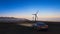 The sports car parked under the windmill to light up  wind energy wind power generation  mountain peak seaside