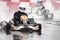 Sports car racing. Two racing cars at speed enter the turn. It`s raining. Spray is flying from under the wheels of the karts. Sel