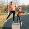 Sports cheerful family, healthy lifestyle, spring portrait of mother and little daughter having fun and running at the stadium