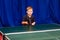 Sports children`s section of table tennis, seven-year-old boy playing table tennis